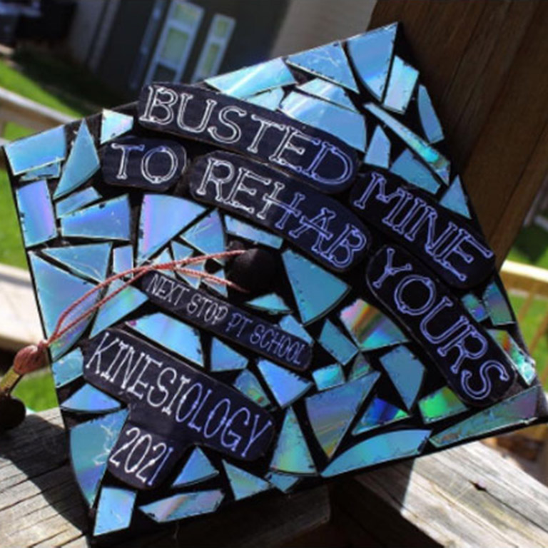 Mortarboard decorated like a mosaic and the words Busted Mine to Rehab Yours.